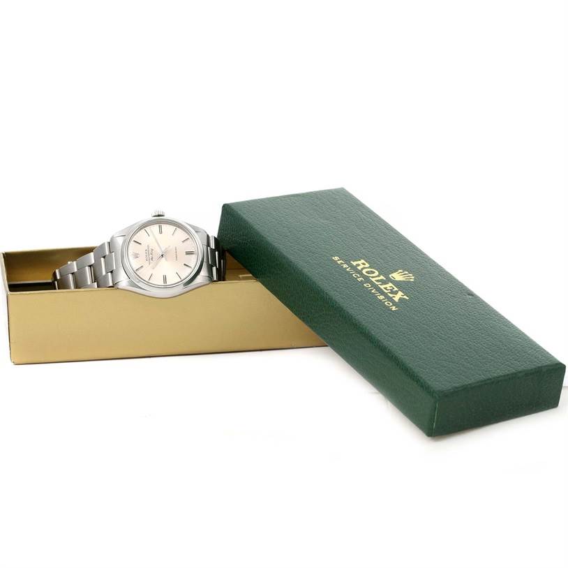 The Vintage Collection Rolex watch is shown at an oblique angle inside its green and gold Rolex box.