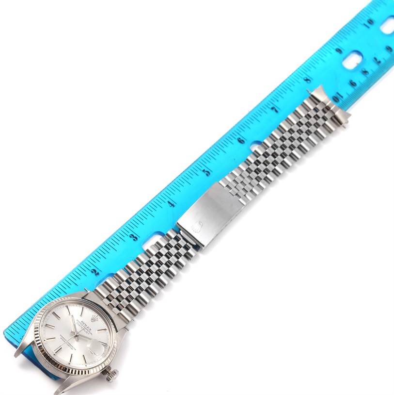 The image shows a Rolex Vintage Collection 16014 Men's Stainless Steel Silver Dial 16014 Men's Stainless Steel Silver Dial watch laid flat with a ruler, highlighting the watch face and stainless steel bracelet.