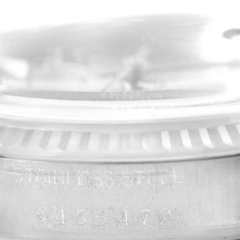 The image shows a close-up angle of the Vintage Collection Rolex watch's case, highlighting the serial number and "STAINLESS STEEL" engraving.