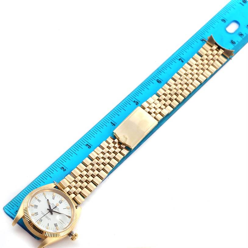 The Rolex Vintage Collection 1503 Men's Yellow Gold White Dial 1503 Men's Yellow Gold White Dial model watch is shown horizontally, featuring the dial, case, and gold bracelet with a clasp, measured against a ruler.