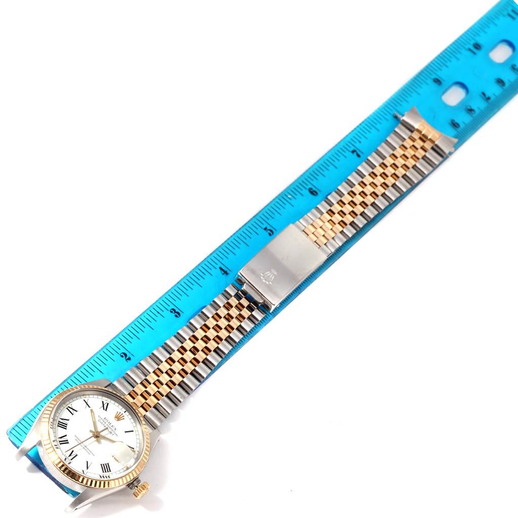 The image shows a Rolex Vintage Collection 16013 Men's Stainless Steel White Dial 16013 Men's Stainless Steel White Dial watch lying flat with its band extended and placed next to a blue ruler.