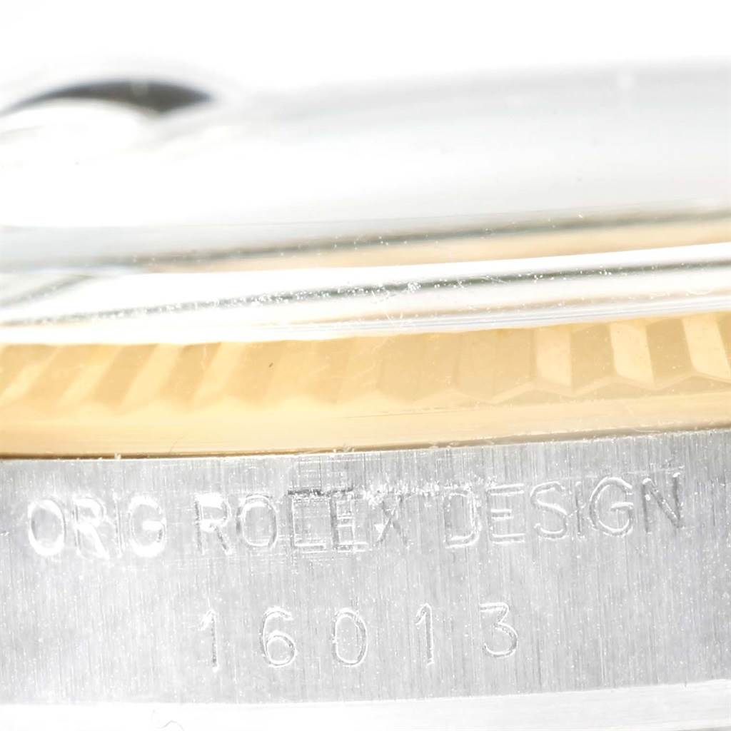 Close-up of the side of a Vintage Collection model Rolex watch, showing the bezel and engraved serial number.