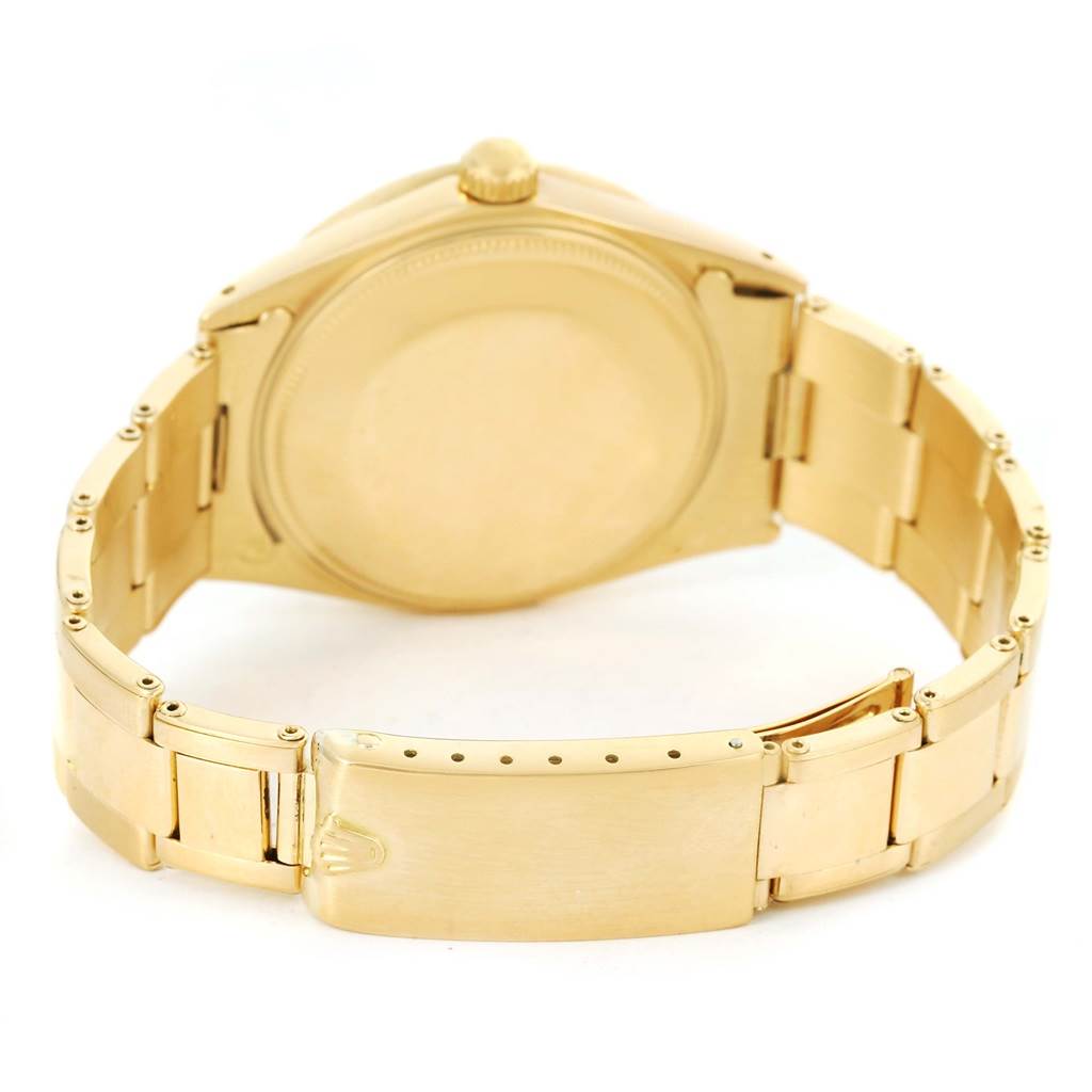 The image shows the back of a Rolex Vintage Collection 1500 Men's Yellow Gold Champagne Dial 1500 Men's Yellow Gold Champagne Dial watch, focusing on its closed case back and bracelet clasp.