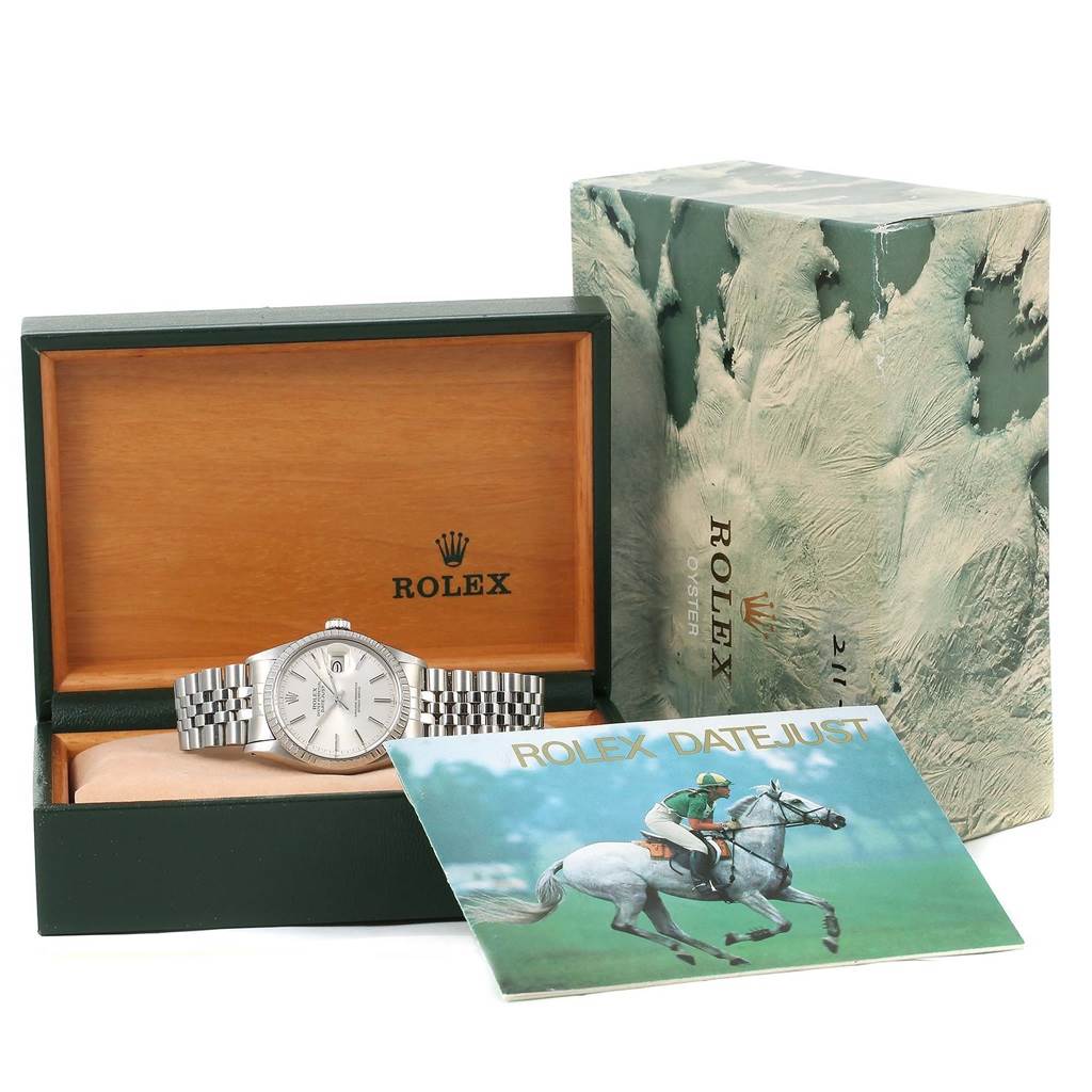 The Rolex Datejust Vintage Collection watch is shown inside its box, with the lid open and documentation displayed in the foreground.