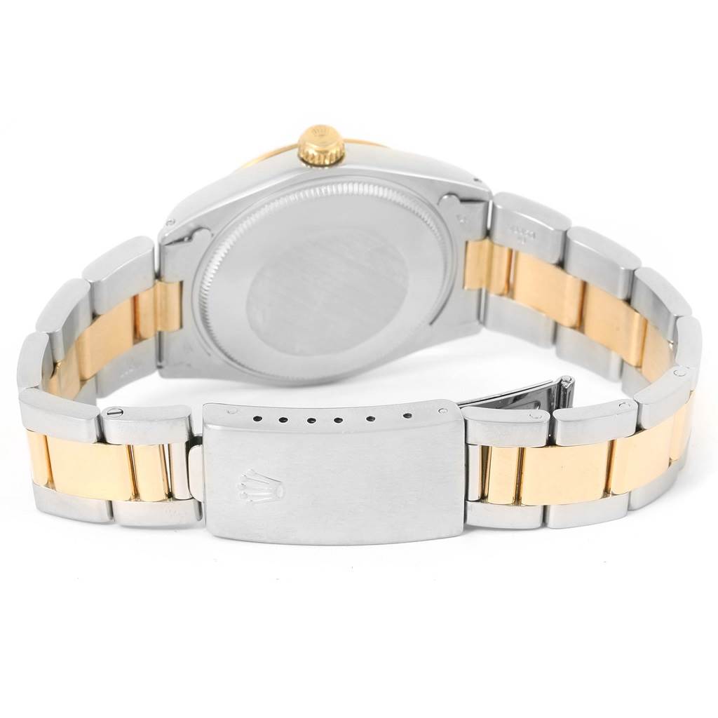 The image shows the back view of the Rolex Vintage Collection 1005 Men's Steel and Gold (two tone) Champagne Dial 1005 Men's Steel and Gold (two tone) Champagne Dial watch, highlighting its case back and two-tone bracelet.