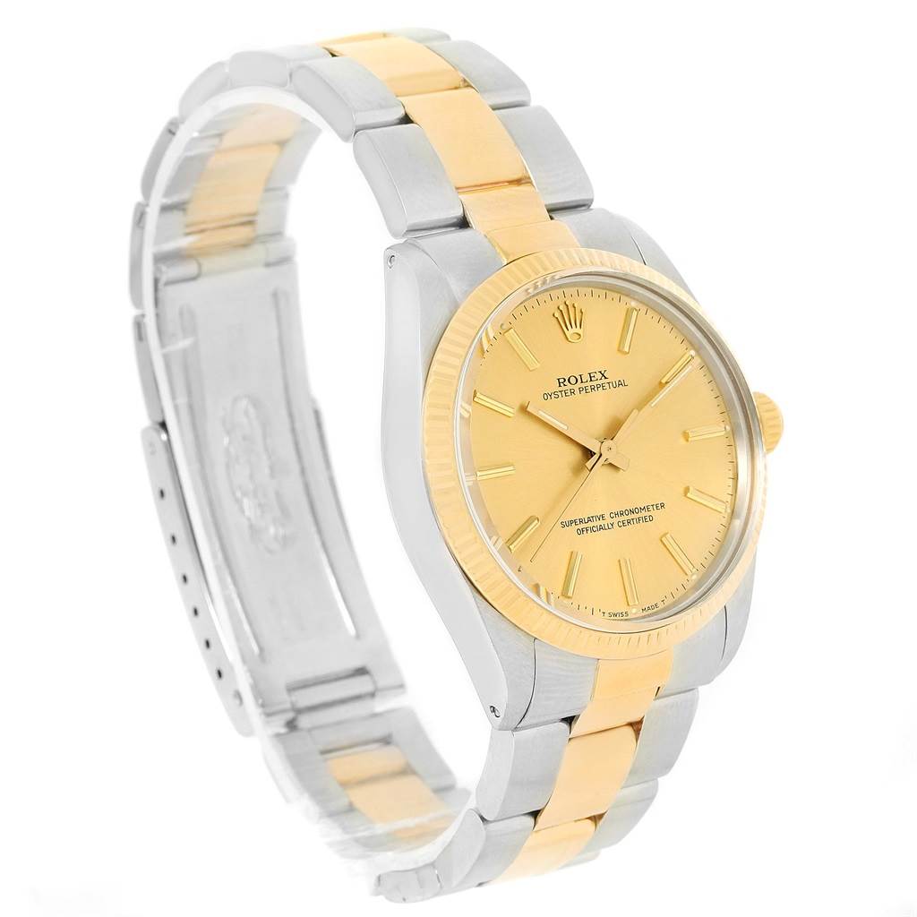 This Rolex Vintage Collection 1005 Men's Steel and Gold (two tone) Champagne Dial 1005 Men's Steel and Gold (two tone) Champagne Dial watch is shown at a tilted angle, highlighting its gold and silver band and gold dial.