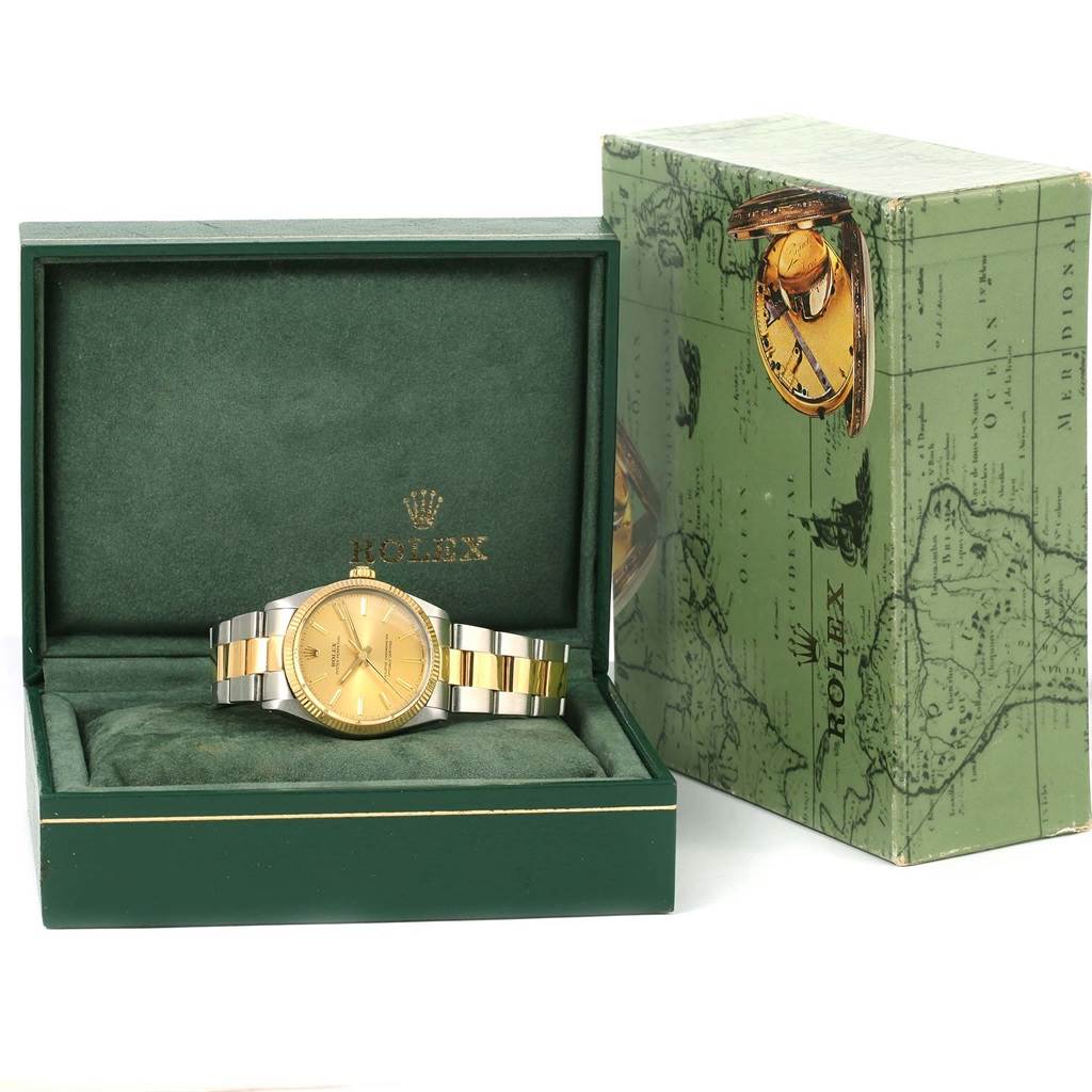 The vintage Rolex watch is shown from a front angle, inside an open green Rolex box, with the packaging displayed beside it.