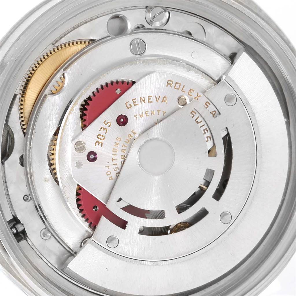 The image shows the internal mechanical movement of the Vintage Collection Rolex watch, focusing on gears and components.