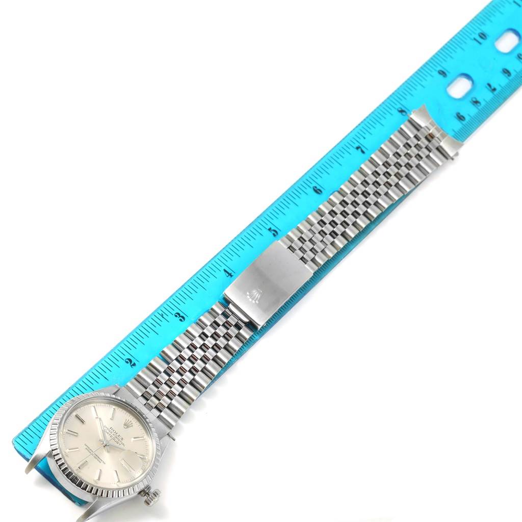 The Rolex Vintage Collection 16000 Men's Stainless Steel Silver Dial 16000 Men's Stainless Steel Silver Dial watch is shown from above, alongside a blue ruler highlighting its length and Jubilee bracelet.