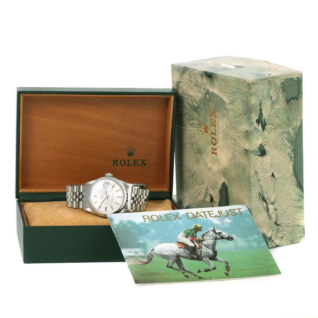 This image shows the Rolex Vintage Collection 16000 Men's Stainless Steel Silver Dial 16000 Men's Stainless Steel Silver Dial watch from the front, its case, packaging, and an accompanying booklet.