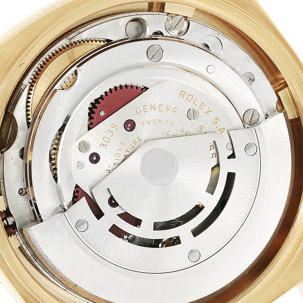 The image shows a close-up of the intricate inner mechanisms of a Vintage Collection Rolex watch, highlighting gears and the rotor.