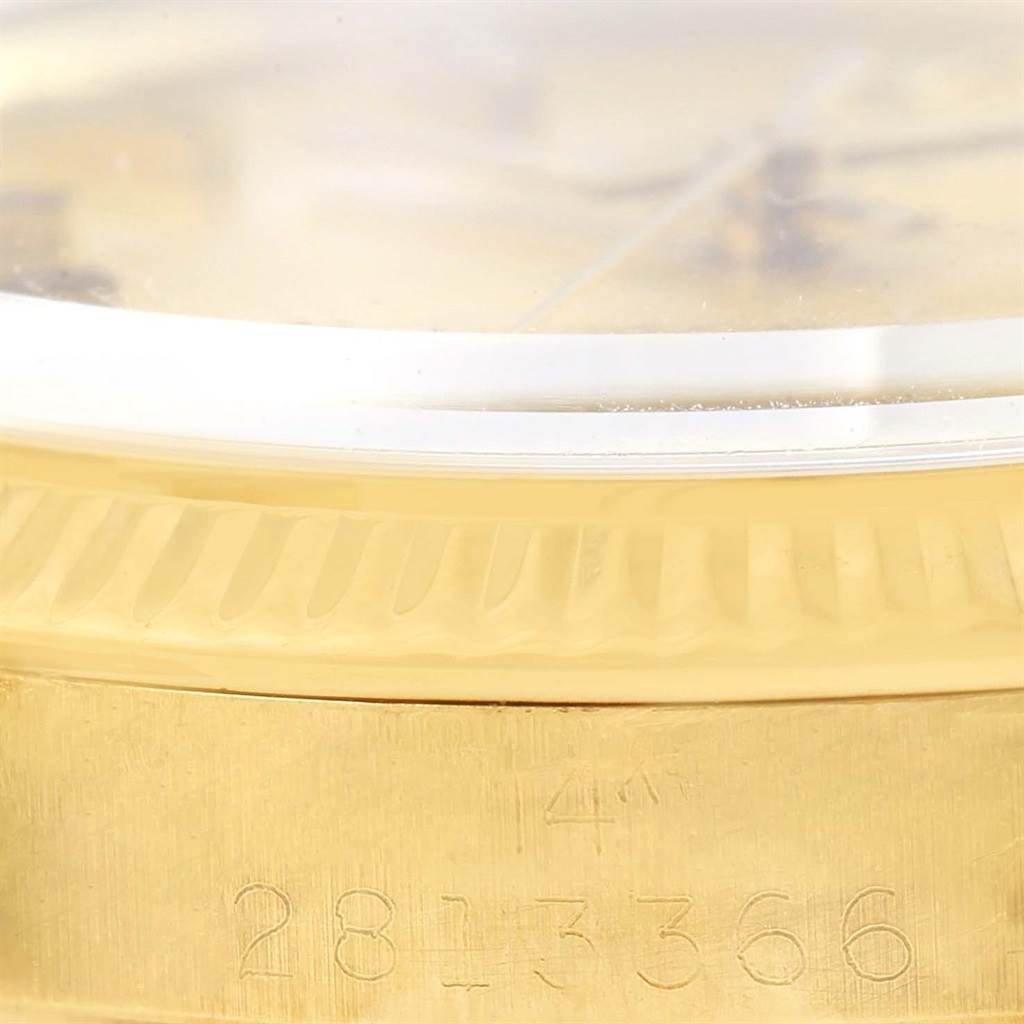 This close-up image of the Rolex Vintage Collection 1503 Men's Yellow Gold Champagne Dial 1503 Men's Yellow Gold Champagne Dial watch shows the side view, detailing the engraved serial number and part of the bezel.