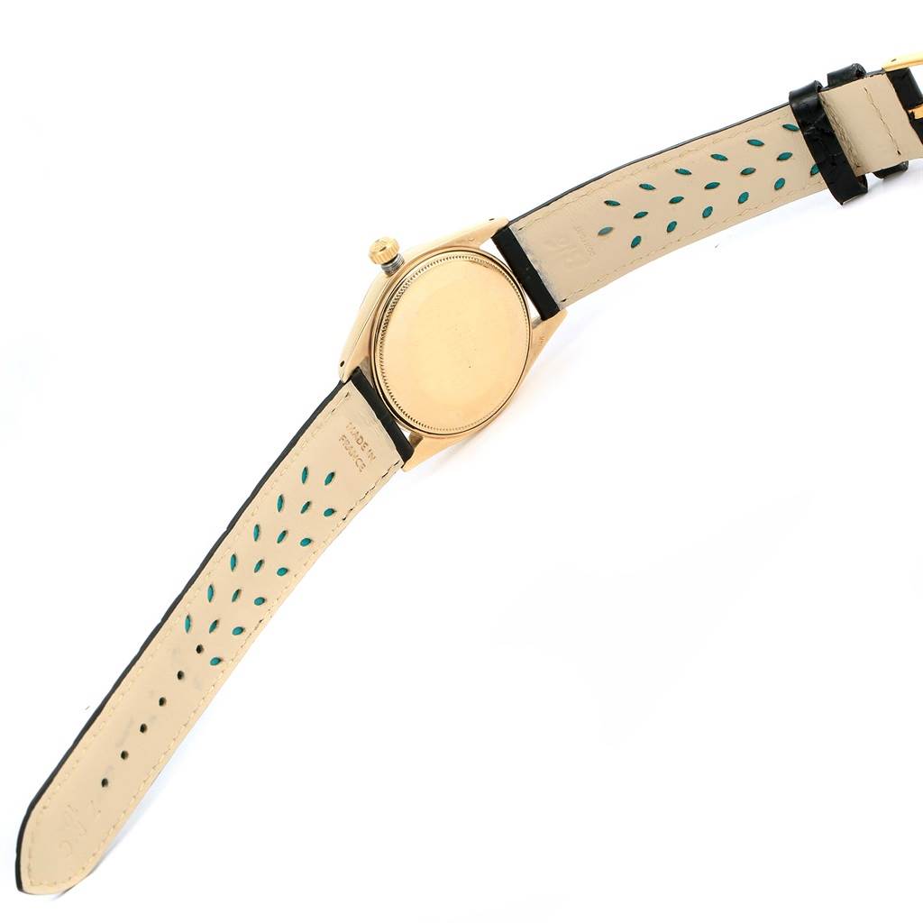 The image shows the backside and straps of a Rolex Vintage Collection 1503 Men's Yellow Gold Champagne Dial 1503 Men's Yellow Gold Champagne Dial watch, displaying the watch case and perforated leather straps.