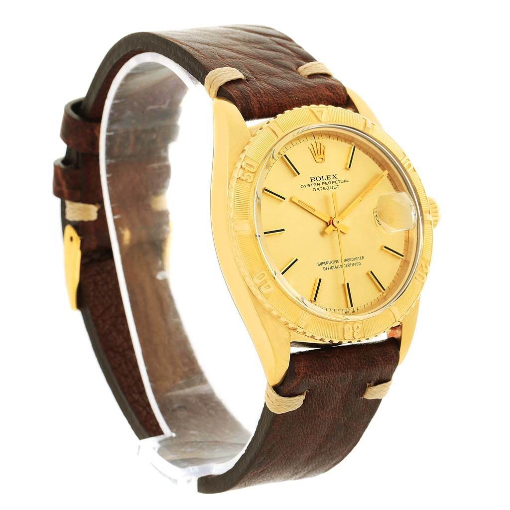 The Rolex Vintage Collection 1625 Men's Yellow Gold Champagne Dial 1625 Men's Yellow Gold Champagne Dial watch is shown at a left-side angle, featuring its gold face, bezel, and brown leather strap.