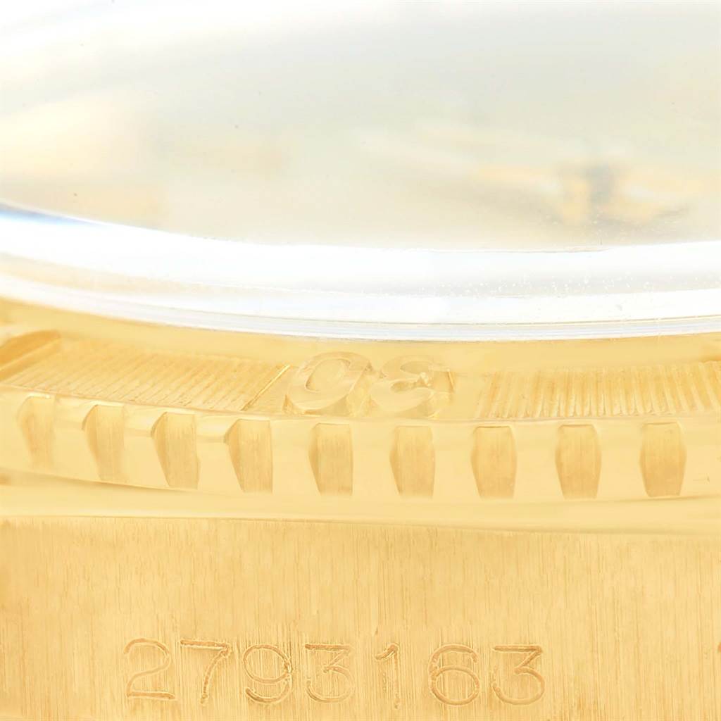 This close-up shows the side profile of the Rolex Vintage Collection 1625 Men's Yellow Gold Champagne Dial 1625 Men's Yellow Gold Champagne Dial model, highlighting the bezel and the case with its serial number.