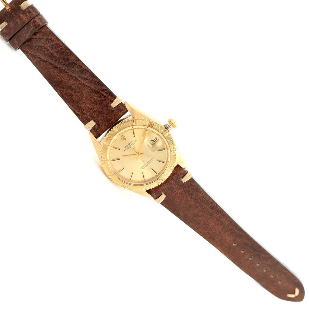 The Rolex Vintage Collection 1625 Men's Yellow Gold Champagne Dial 1625 Men's Yellow Gold Champagne Dial model watch is shown from a top-down angle, displaying its face, bezel, crown, and leather strap.