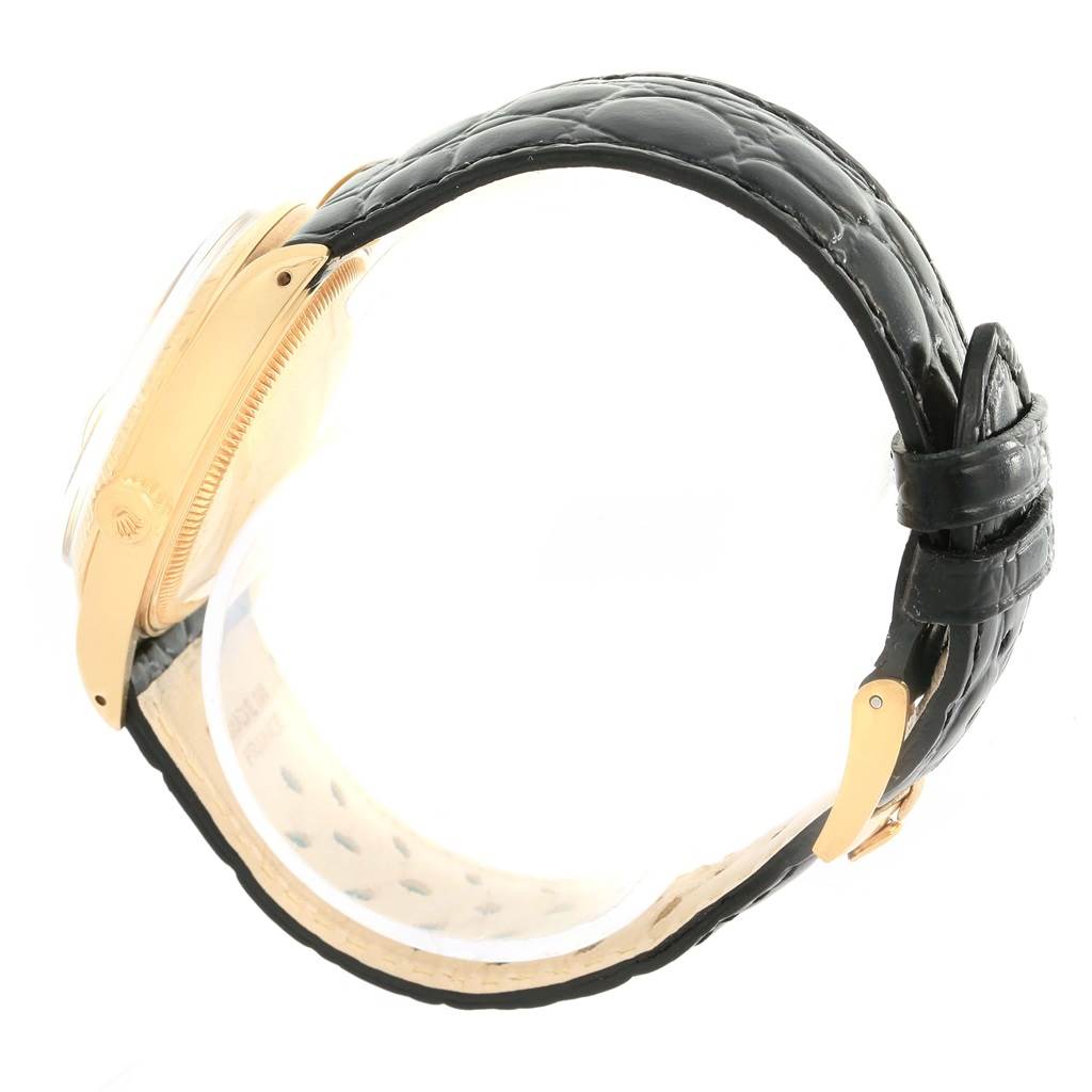 This side-angle view of the Rolex Vintage Collection 1503 Men's Yellow Gold Silver Dial 1503 Men's Yellow Gold Silver Dial watch highlights the watch case, crown, and black leather strap.