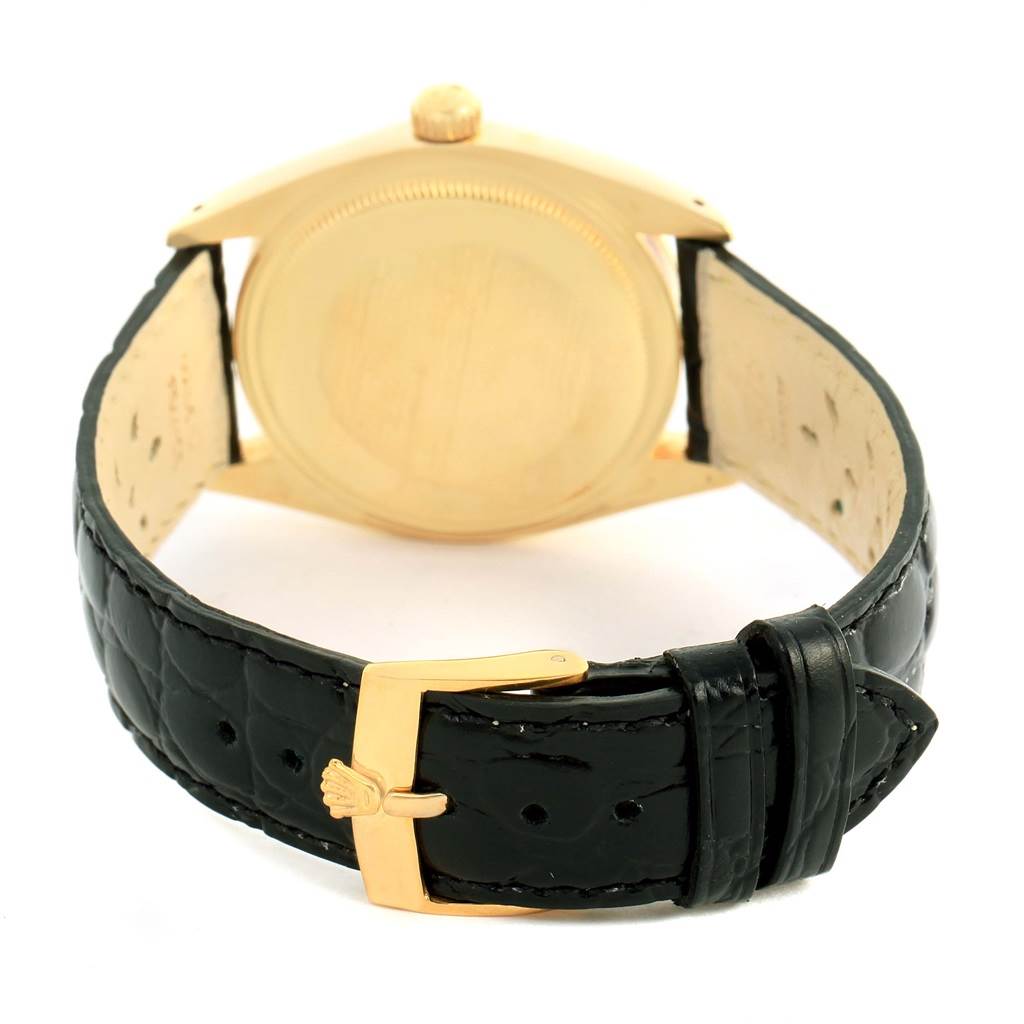 This image shows the back view of the Rolex Vintage Collection 1503 Men's Yellow Gold Silver Dial 1503 Men's Yellow Gold Silver Dial watch, focusing on the case back and leather strap with a gold buckle.