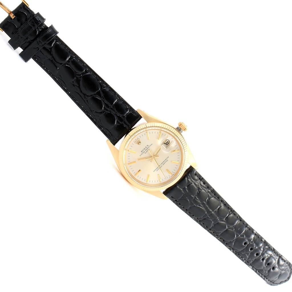 The image shows a Rolex Vintage Collection 1503 Men's Yellow Gold Silver Dial 1503 Men's Yellow Gold Silver Dial watch, displaying its black leather strap, gold case, and dial from a top-down angle.