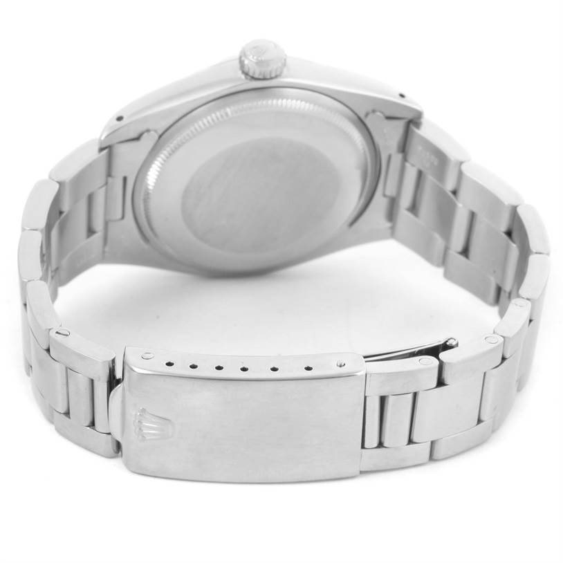 The image shows the back and clasp of a Vintage Collection Rolex watch, highlighting its stainless steel bracelet and closed case back.