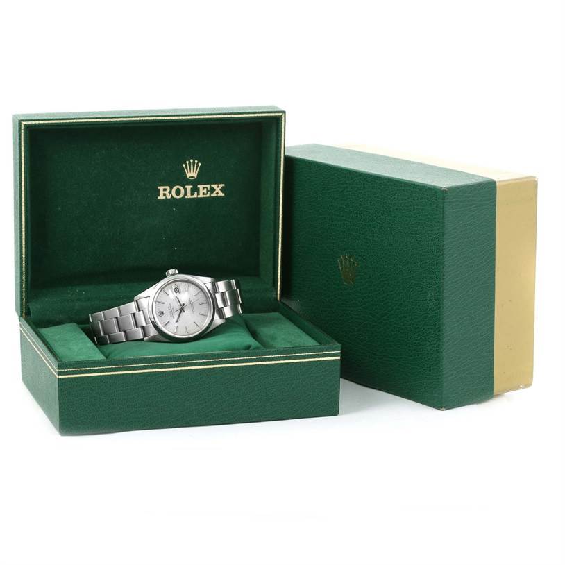 The Rolex Vintage Collection 1500 Men's Stainless Steel Silver Dial 1500 Men's Stainless Steel Silver Dial watch is shown at a front angle nestled inside a green, open presentation box with the brand logo.