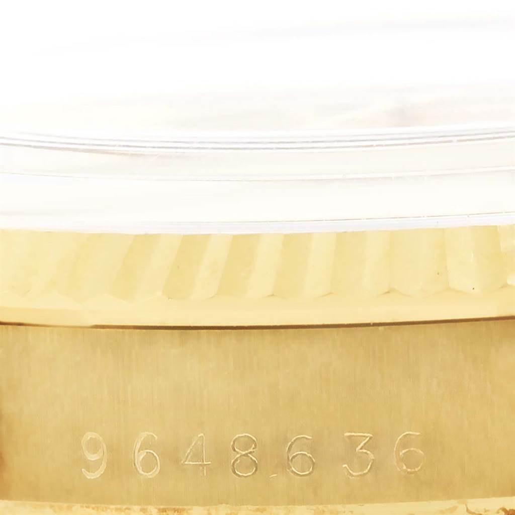 The image shows the side of the Rolex Vintage Collection 15037 Men's Yellow Gold Champagne Dial 15037 Men's Yellow Gold Champagne Dial model, focusing on the serial number engraving and part of the bezel.