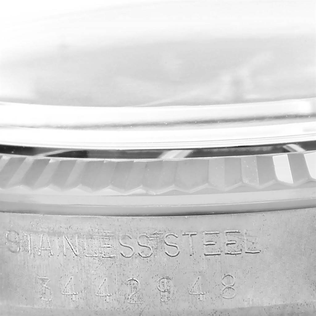 The image shows a close-up of the side of a stainless steel case of a Rolex Vintage Collection 1601 Men's Stainless Steel Black Dial 1601 Men's Stainless Steel Black Dial model with the serial number.