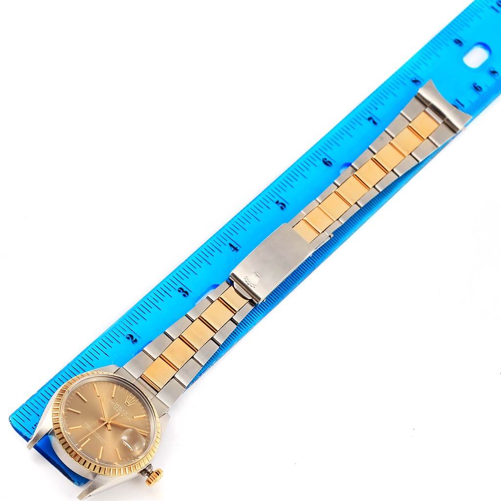 The image shows the Rolex Vintage Collection 1505 Men's Steel and Gold (two tone) Champagne Dial 1505 Men's Steel and Gold (two tone) Champagne Dial watch from a top-down angle, highlighting the face, band, and clasp against a blue ruler.