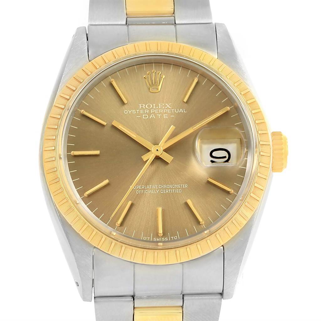 This is a front view of a Rolex Vintage Collection 1505 Men's Steel and Gold (two tone) Champagne Dial 1505 Men's Steel and Gold (two tone) Champagne Dial Oyster Perpetual Date watch, showing its gold dial, hands, bezel, and partially the bracelet.