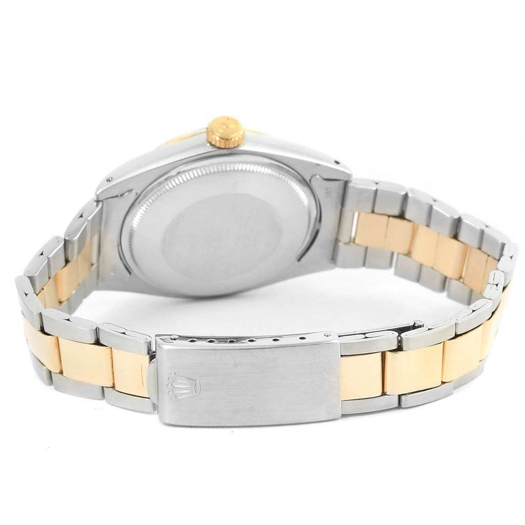 The image shows the back view of a Rolex Vintage Collection 1505 Men's Steel and Gold (two tone) Champagne Dial 1505 Men's Steel and Gold (two tone) Champagne Dial watch, highlighting its case, crown, and two-tone bracelet.