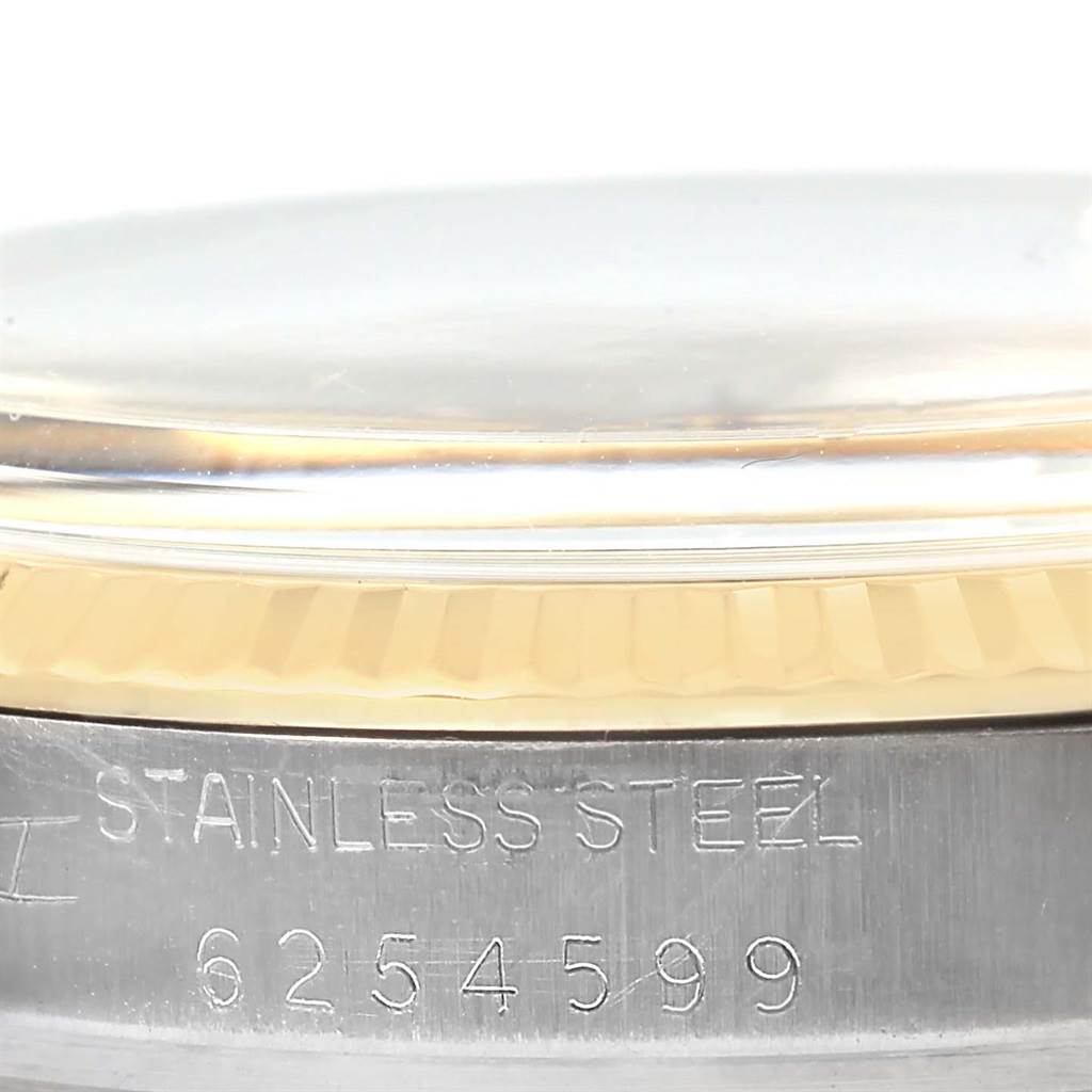 The image shows a close-up of the side of a Rolex Vintage Collection 16013 Men's Stainless Steel Champagne Dial 16013 Men's Stainless Steel Champagne Dial watch, displaying the stainless steel case and part of the bezel with engraved serial numbers.