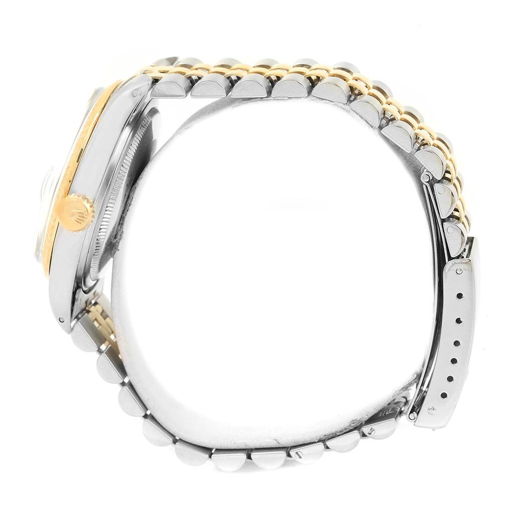 This side view of the Rolex Vintage Collection 16013 Men's Stainless Steel Champagne Dial 16013 Men's Stainless Steel Champagne Dial watch shows the crown, bezel, and bracelet.