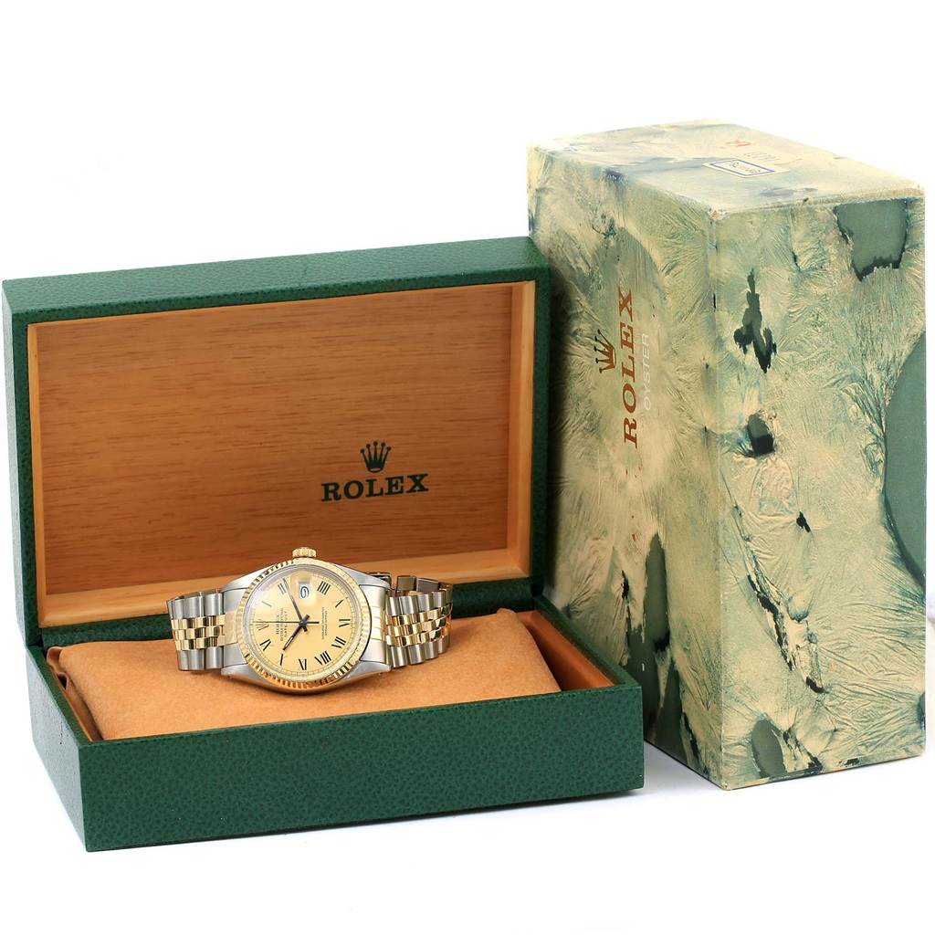 The Rolex Vintage Collection 16013 Men's Stainless Steel Champagne Dial 16013 Men's Stainless Steel Champagne Dial watch is shown at a front angle inside its green and wooden presentation box and protective covering.