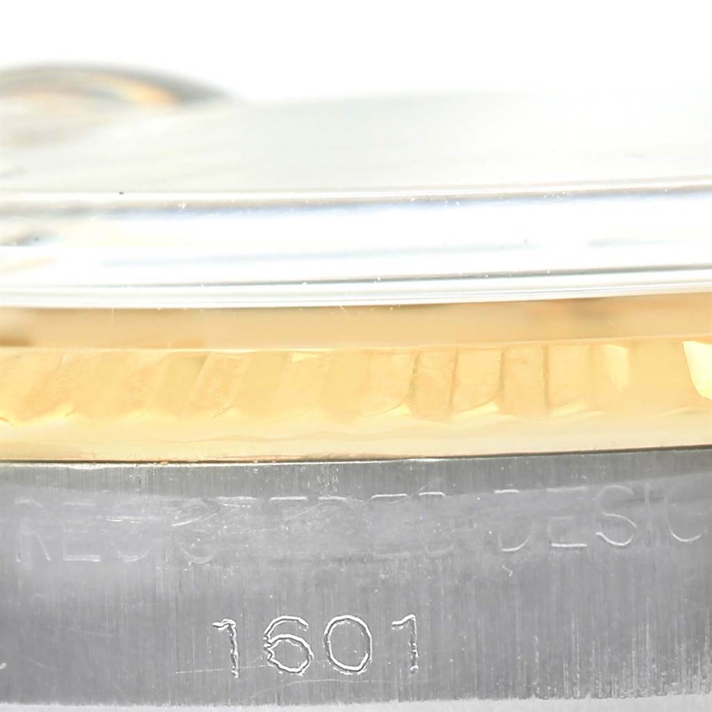 This close-up shows the side of the Rolex Vintage Collection 1601 Men's Stainless Steel Champagne Dial 1601 Men's Stainless Steel Champagne Dial model, focusing on the fluted bezel and case engraving with the model number 1601.