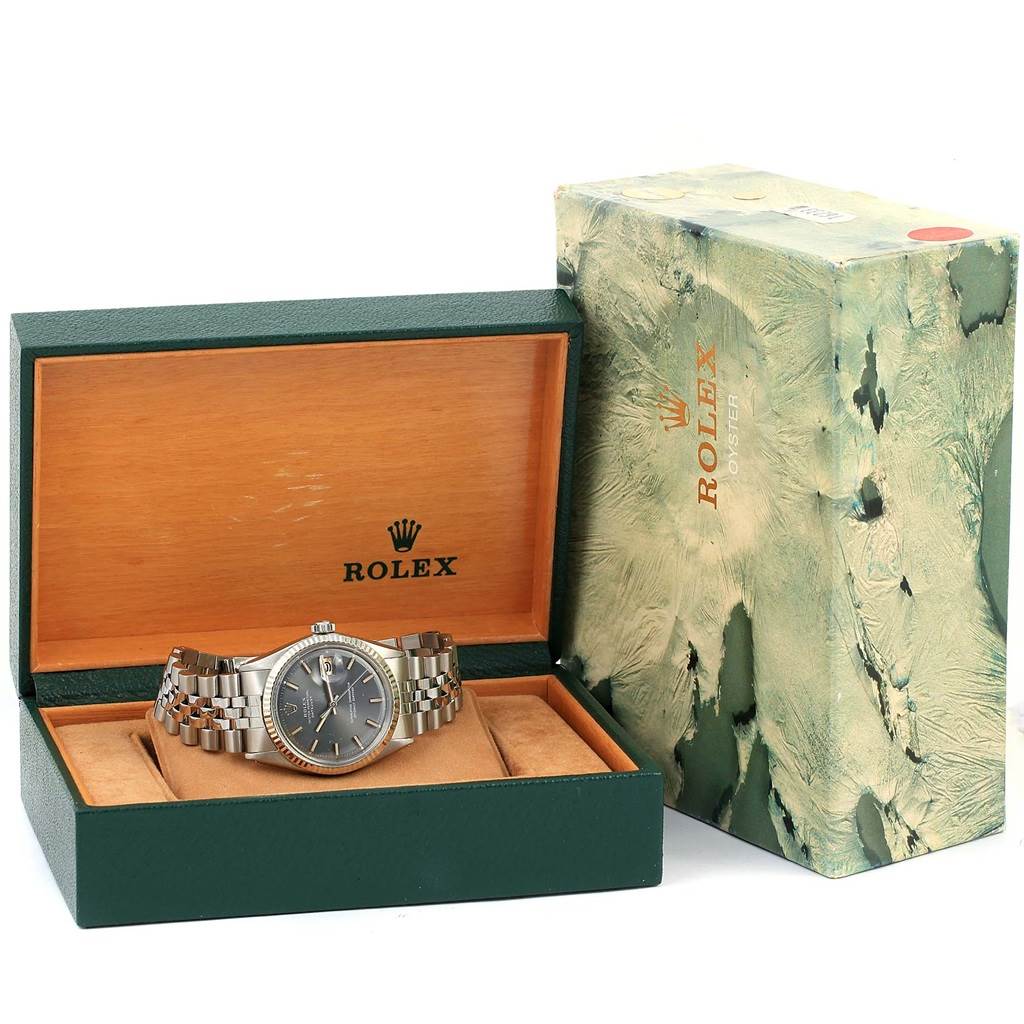 The image shows a Rolex Vintage Collection 1603 Men's Stainless Steel Grey Dial 1603 Men's Stainless Steel Grey Dial watch in its open green and wooden box, with the outer decorative box next to it.