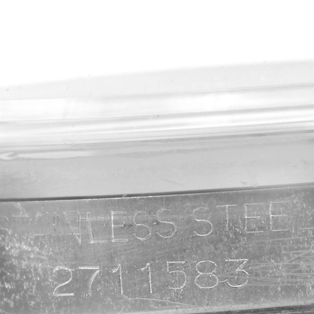 The image shows a close-up of the serial number engraving on the stainless steel case of a Rolex Vintage Collection 1500 Men's Stainless Steel Silver Dial 1500 Men's Stainless Steel Silver Dial watch.
