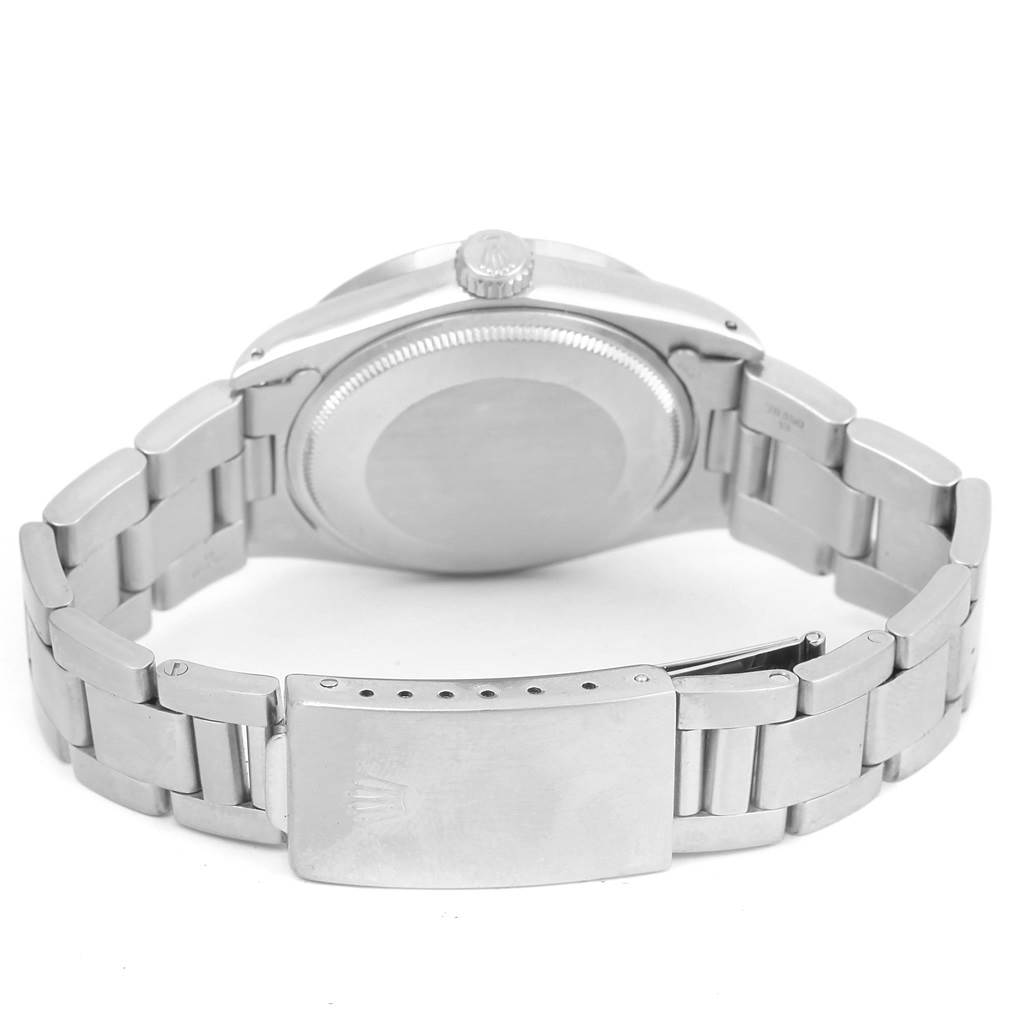 This photo of the Rolex Vintage Collection 1500 Men's Stainless Steel Silver Dial 1500 Men's Stainless Steel Silver Dial watch shows the stainless steel case back, crown, and bracelet with a clasp, viewed from the backside.