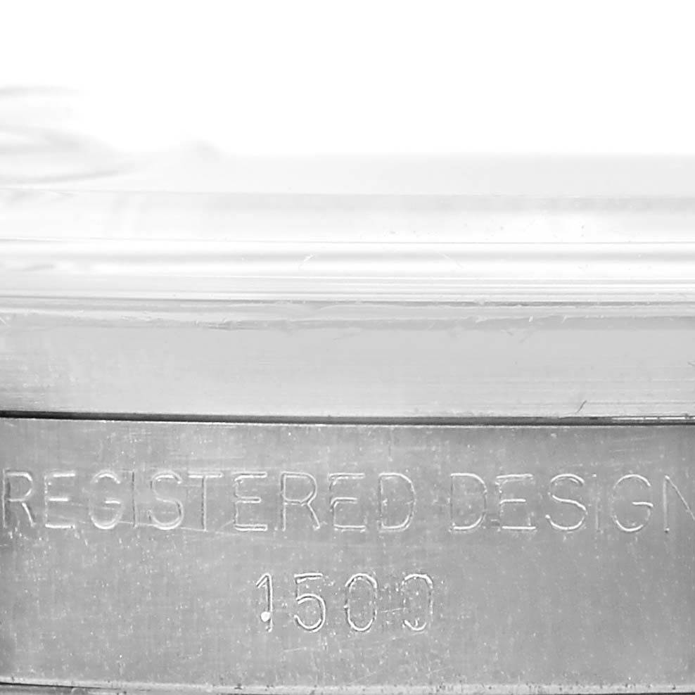 The image shows a close-up of the edge of a Rolex Vintage Collection 1500 Men's Stainless Steel Silver Dial 1500 Men's Stainless Steel Silver Dial watch, highlighting the engraving "REGISTERED DESIGN 1500."