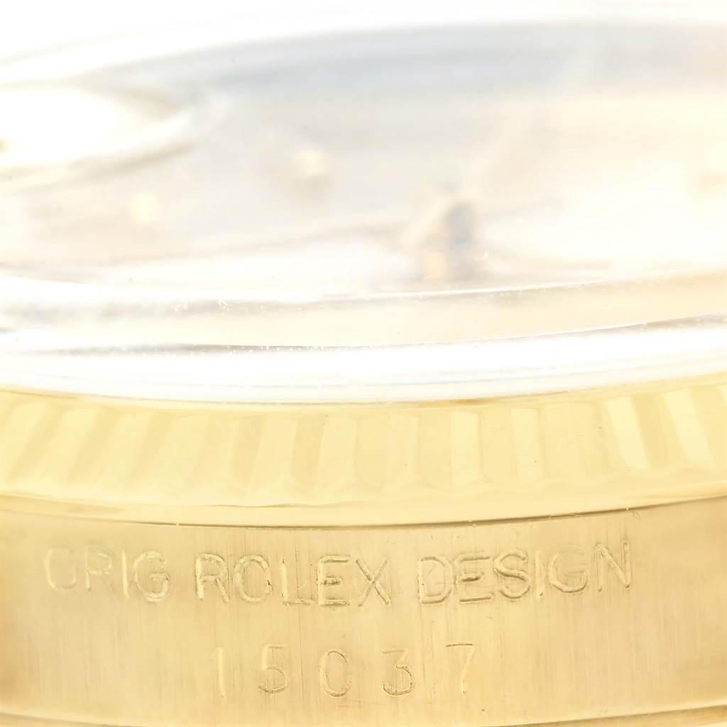 This close-up image shows the side of the case and the bezel of a Rolex Vintage Collection 15037 Men's Yellow Gold Silver Dial 15037 Men's Yellow Gold Silver Dial model, highlighting the "ORIG ROLEX DESIGN" engraving.