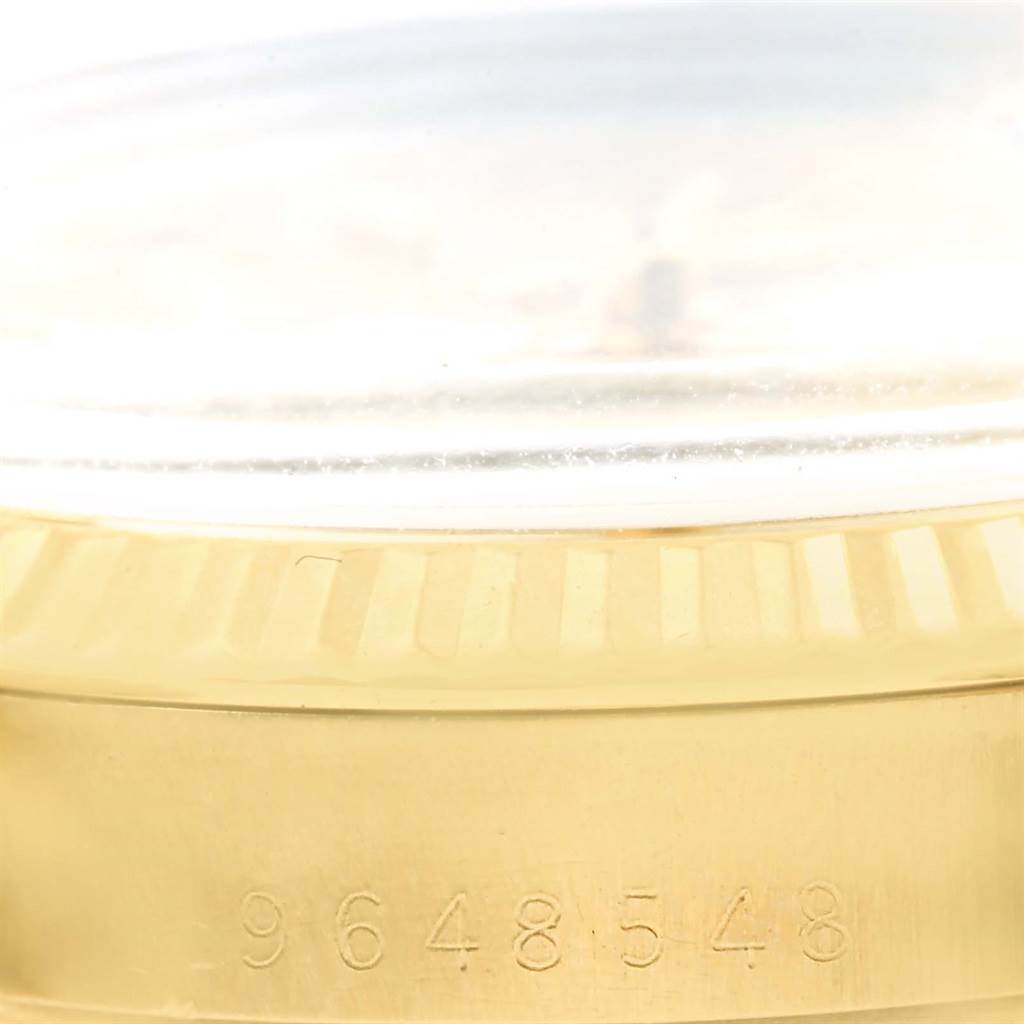 This image shows a close-up of the serial number and bezel of a Rolex Vintage Collection 15037 Men's Yellow Gold Silver Dial 15037 Men's Yellow Gold Silver Dial model watch.