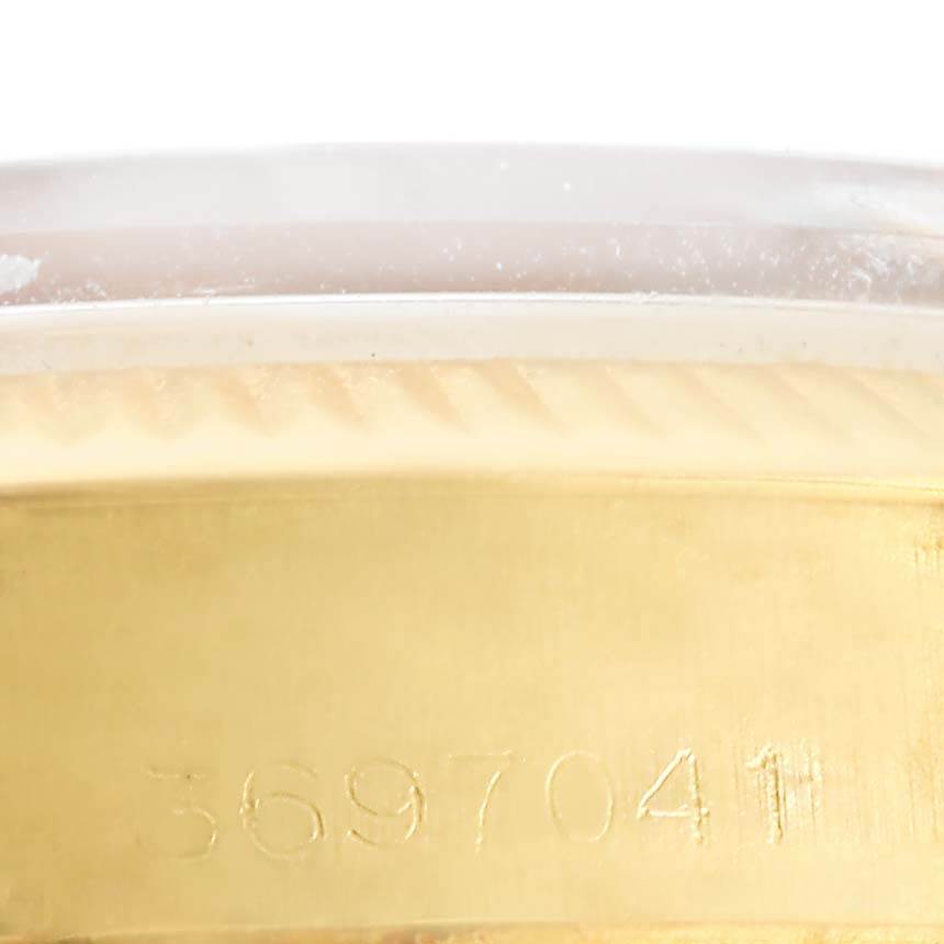 This close-up image shows the serial number engraving on the gold case of the Vintage Collection Rolex watch.