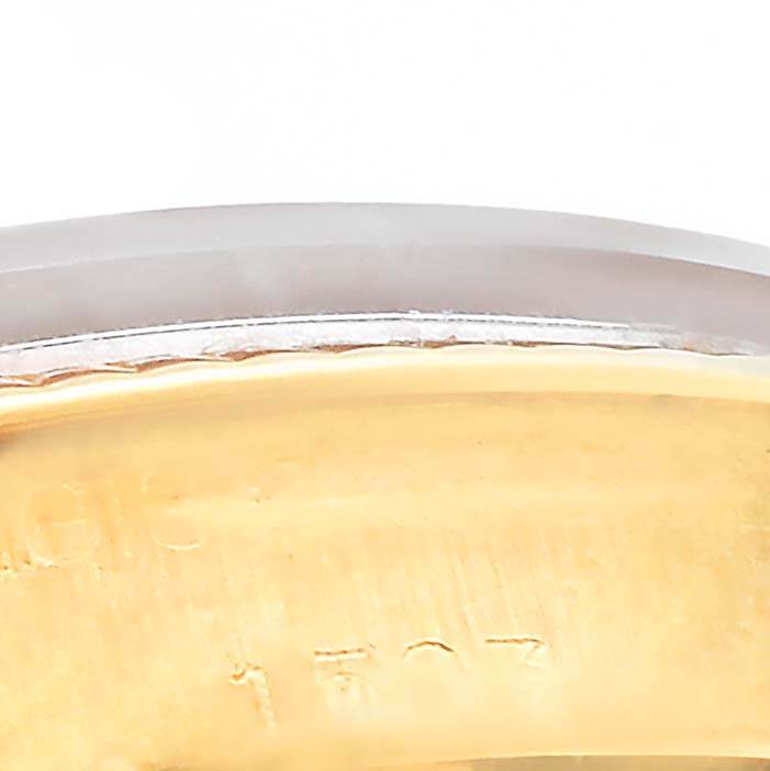 This close-up image of the Rolex Vintage Collection 1503 Men's Yellow Gold White Dial 1503 Men's Yellow Gold White Dial watch model shows a portion of its case and bezel, partially capturing engravings.