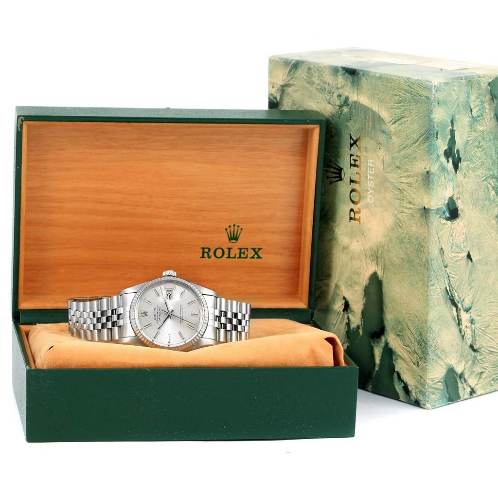 The image shows a Rolex Vintage Collection 16014 Men's Stainless Steel Silver Dial 16014 Men's Stainless Steel Silver Dial watch from the front, placed in its green and wooden box, alongside the outer packaging.
