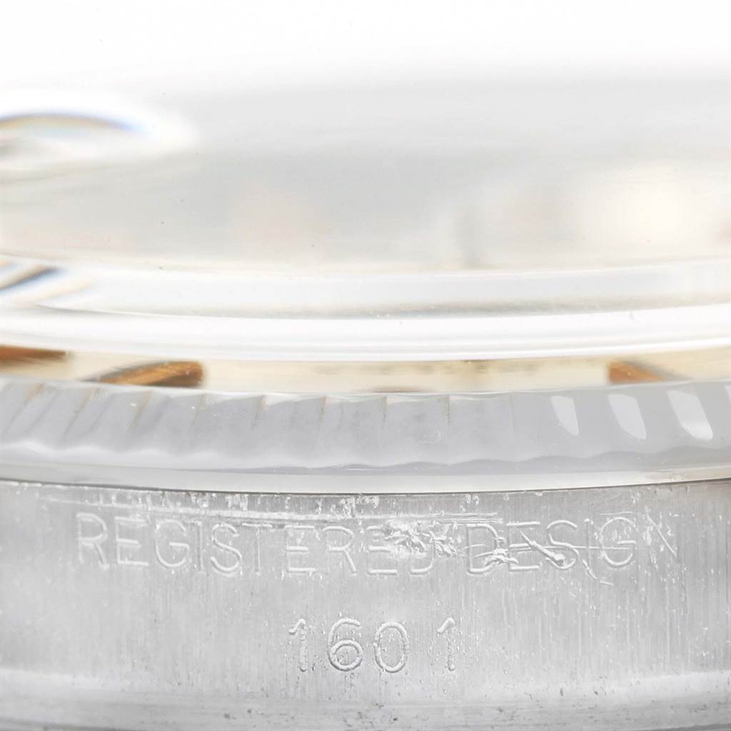 This close-up image shows the side case and partial bezel of the Rolex Vintage Collection 1601 Men's Stainless Steel Black Dial 1601 Men's Stainless Steel Black Dial model, highlighting the "REGISTERED DESIGN 1601" engraving.