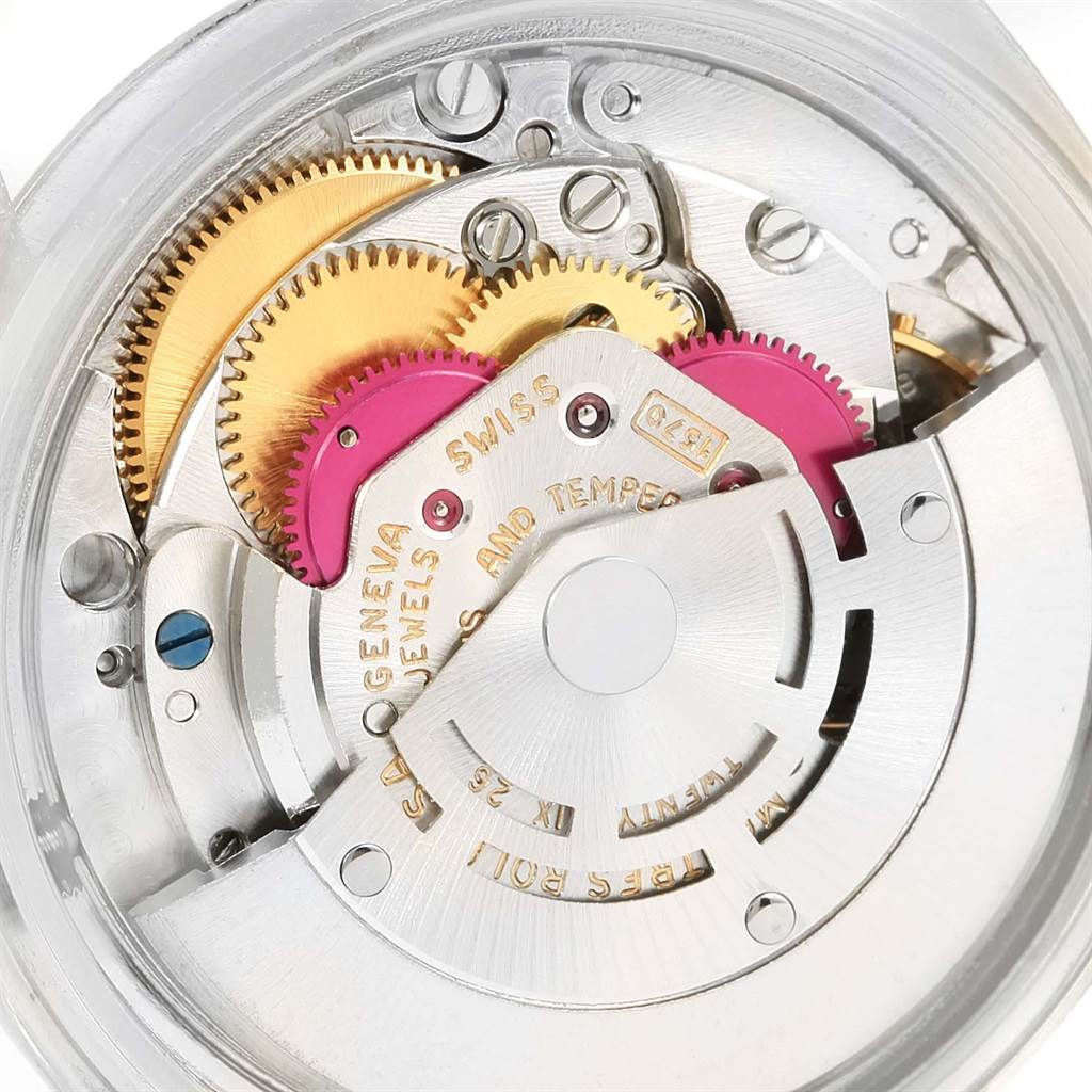 The image shows the internal mechanics of a Vintage Collection Rolex watch, highlighting gears and intricate details.