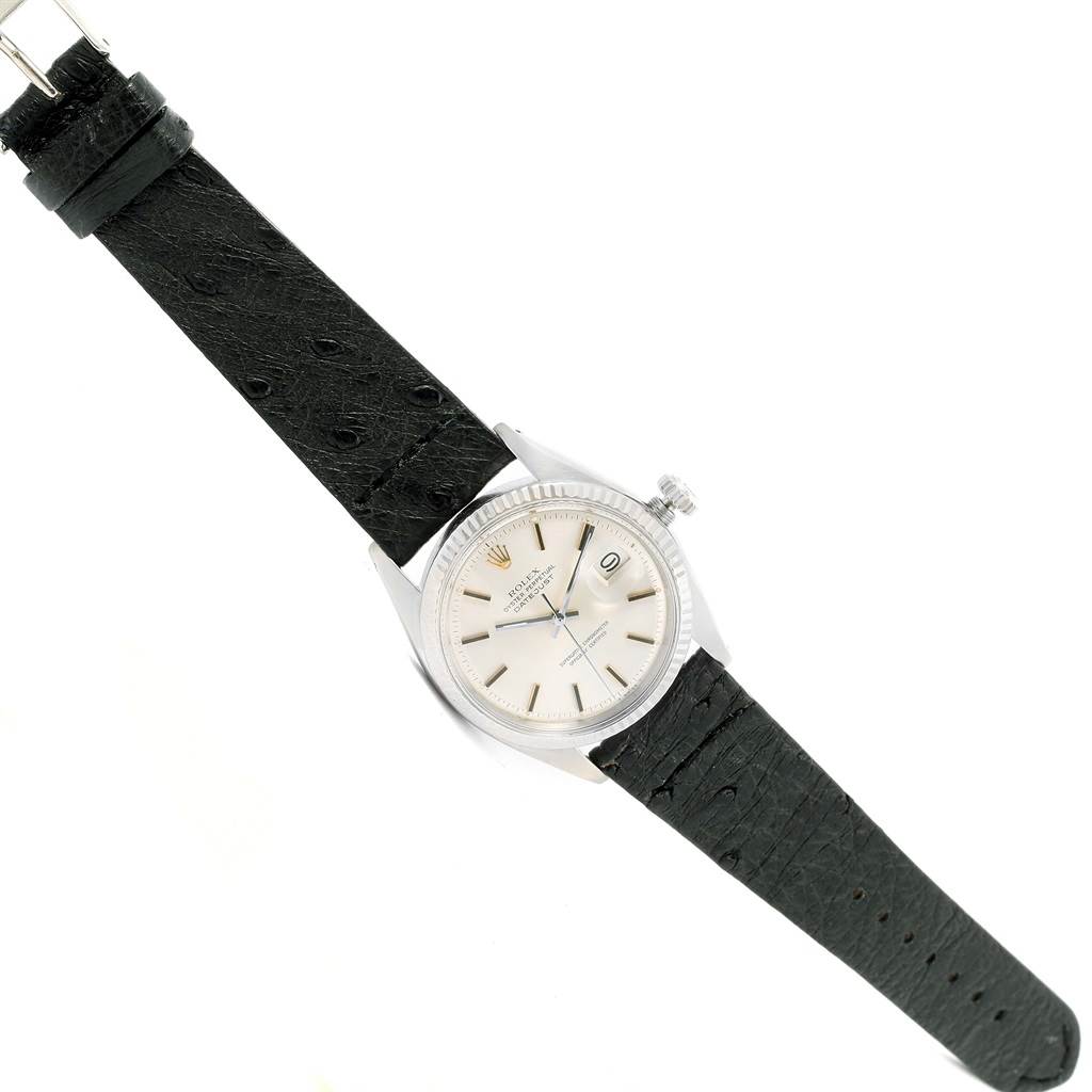 The image shows a top-down view of a Vintage Collection Rolex watch with a white dial and black leather strap.