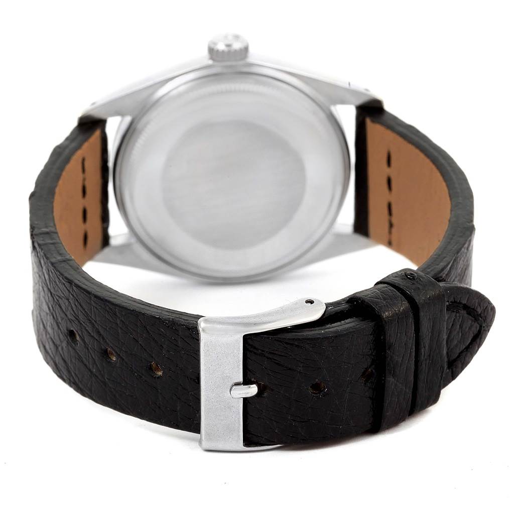 The image shows the back view of a Rolex Vintage Collection 1601 Men's Stainless Steel Black Dial 1601 Men's Stainless Steel Black Dial watch with a black leather strap and a metal buckle.