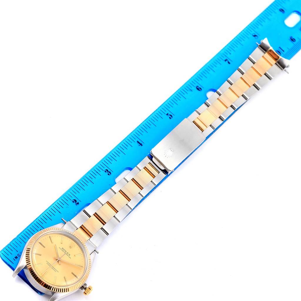 The Rolex Vintage Collection 1005 Men's Steel and Gold (two tone) Champagne Dial 1005 Men's Steel and Gold (two tone) Champagne Dial model watch is shown laid flat with its full band placed against a ruler for measurement.