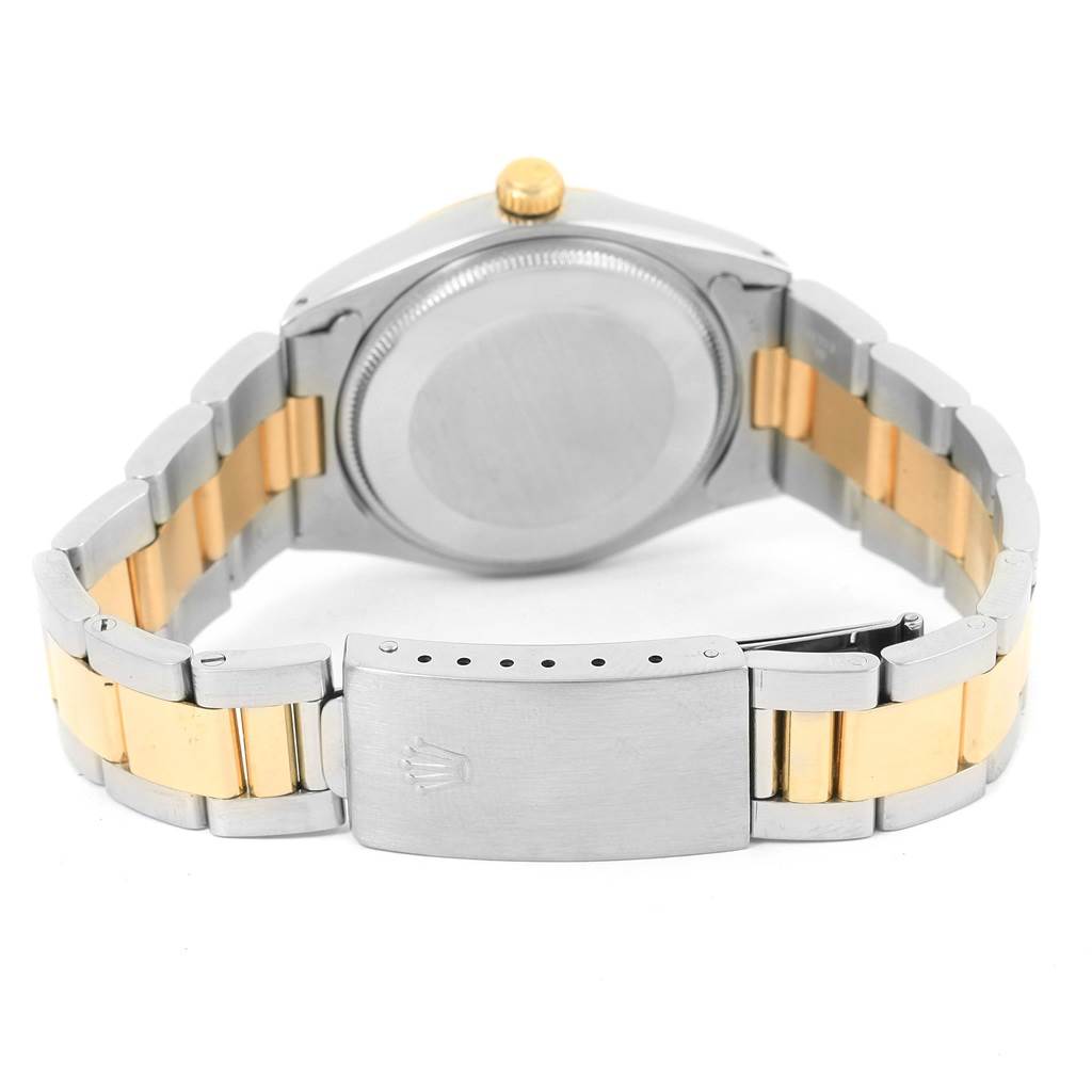 The image shows the back and clasp of a Rolex Vintage Collection 1005 Men's Steel and Gold (two tone) Champagne Dial 1005 Men's Steel and Gold (two tone) Champagne Dial watch at an angle displaying its metal and gold links.