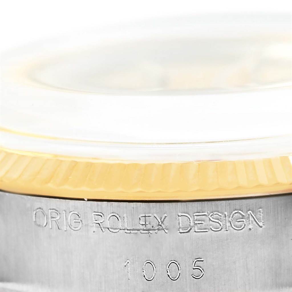 This is a close-up angle showing the side view of the case and bezel of the Rolex Vintage Collection 1005 Men's Steel and Gold (two tone) Champagne Dial 1005 Men's Steel and Gold (two tone) Champagne Dial model with the inscription "ORG ROLEX DESIGN 1005."